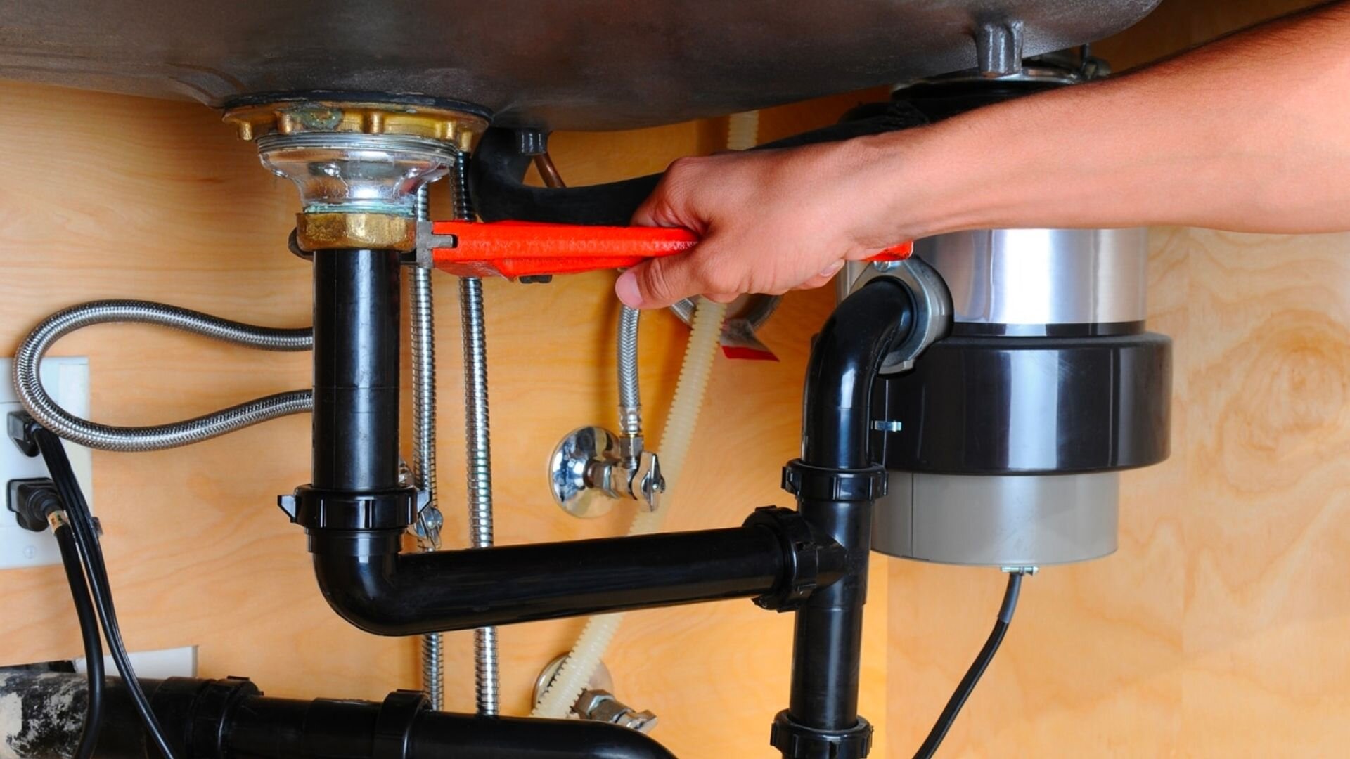 Orange Spanner Fixing Black Pipe